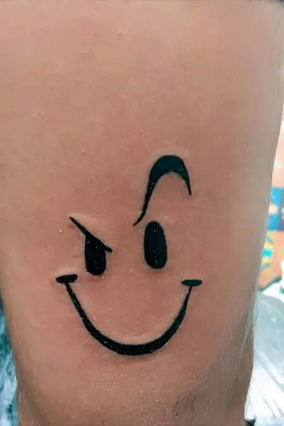 100 Amazing Tattoo Designs for Men You Must Try! 14 Winking Smiley Face Tattoo