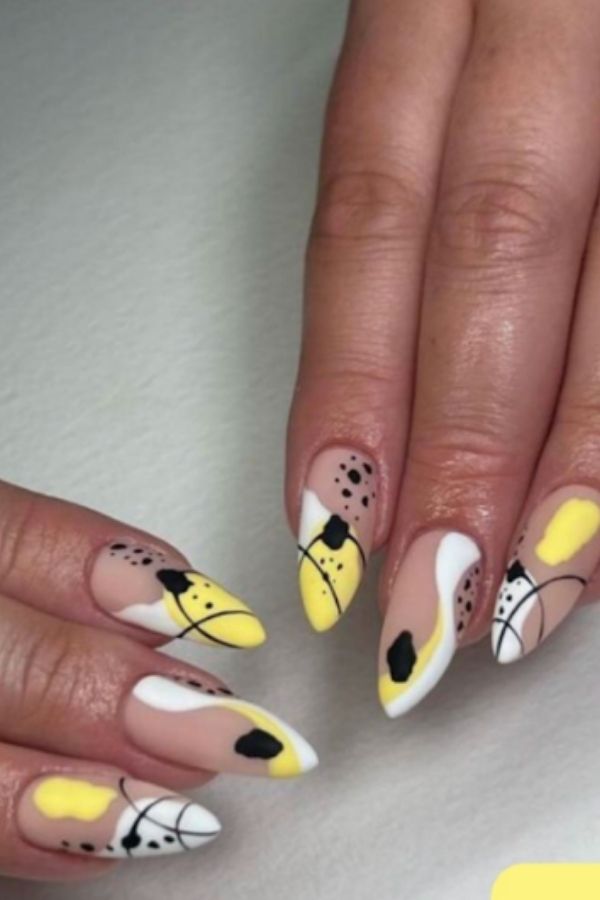 34 Soft to Bold Cutest Yellow Nail Designs Ideas Perfect for Summer and Beyond 22 Abstract Yellow Nails with Black Patterns
