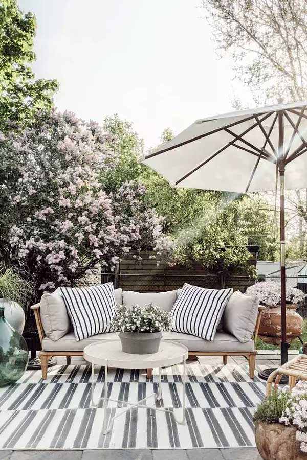44 Back Patio Ideas on a Budget to Transform Small Outdoor Spaces 15 Outdoor Rug to Ground the Space