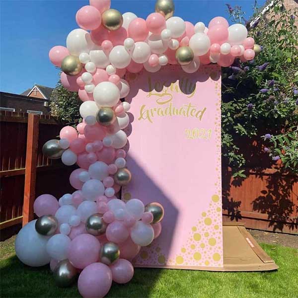 23 Picture-Perfect Graduation Party Backdrop Ideas That Will Wow Your Guests 7 Pink Princess-Themed Grad Backdrop