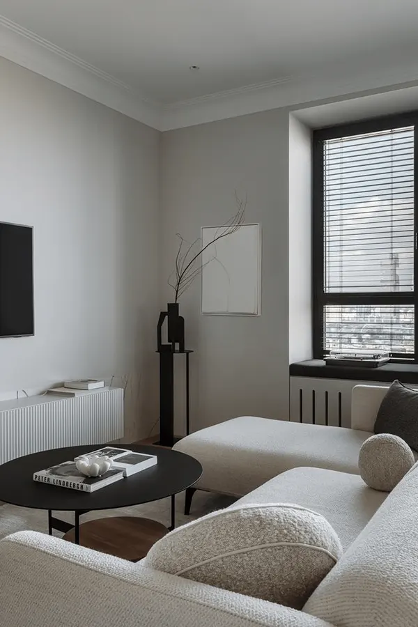 Compact Japandi Living Room Design

This small Japandi living room leans Scandinavian with a neutral sectional and clean layout. A black coffee table adds contrast, while a slatted TV unit and styled pillar bring subtle texture and balance.