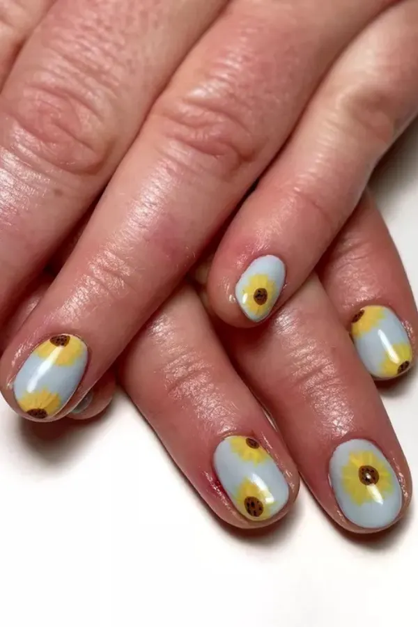 41 Bright and Cheerful Sunflower Nail Designs Ideas You’ll Love to Copy 27 Pale Blue Base Sunflower Manicure