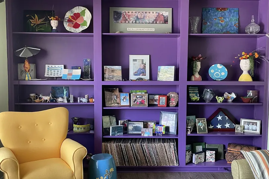 Eclectic Living Room With Purple Bookshelf